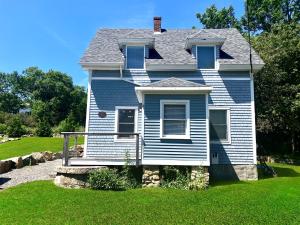 a blue house with a green lawn in front of it at Acadia View Cottage Peaceful, Pet Friendly, Fire Pit, Near Peaks and Echo Lake in Hall Quarry +56 photos