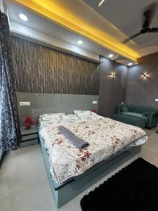 a bedroom with a bed with a knife on it at Luxury studios in Ghaziabad