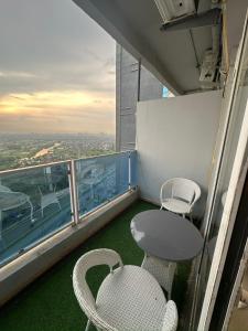 a balcony with a table and chairs on a building at Luxury studios in Ghaziabad