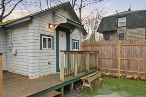 a wooden deck with a house and a fence at Davis Outpost Pet-Friendly Quiet Cabin w AC Screened Sunroom Walk to Trails in Otter Creek +16 photos