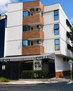 a building with a sign in front of it at Hotel 14-04 in Cali