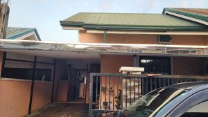 a house with a fence in front of it at Casa Minsorado in General Trias +8 photos