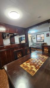 a dining room with a table and a couch at Casa Minsorado in General Trias