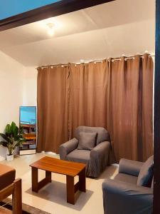 a living room with a couch and a coffee table at Flo Island Home in General Luna