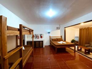 a living room with a bunk bed and a table at Flo Island Home in General Luna
