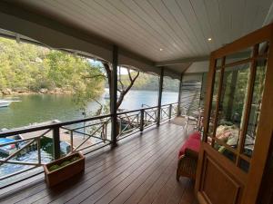 a balcony of a house with a view of a river at The Haven Cottage Point Sydney in Cowan