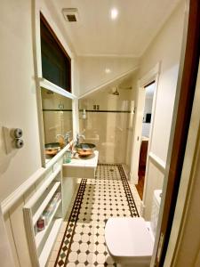 a bathroom with a sink and a toilet and a tub at The Haven Cottage Point Sydney in Cowan +40 photos