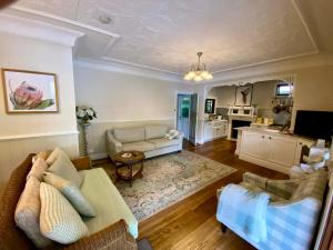 a living room with a couch and a table at The Haven Cottage Point Sydney in Cowan