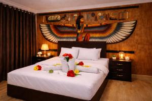 a bedroom with a bed with flowers on it at phoenix Pyramids- roof top in Cairo