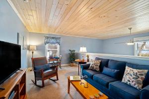 a living room with a blue couch and a tv at Captain Swift Inn in Camden