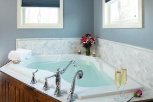 a bathroom with a bath tub with a sink at Captain Swift Inn in Camden +61 photos