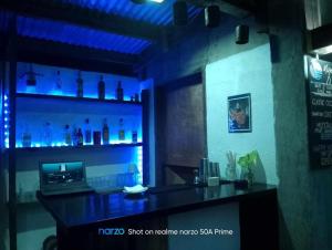 a bar in a restaurant with a blue light at El Nido Bayview in El Nido