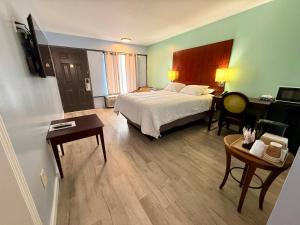 a hotel room with a bed and a desk at Americas Best Value Inn Suites & Studios Blytheville by Sonesta in Blytheville