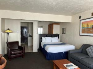a hotel room with a bed and a couch at Capitola Venetian Vacation Rentals in Capitola