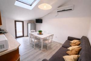 a living room with a couch and a table at Apartments Urban Porec in Poreč