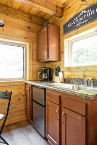 a kitchen with a sink and a stove at Theodore Tiny Cabin- RRG Hot Tub Pet Friendly in Slade