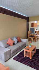 a living room with a couch and a table at Oasis House 2 in Tocumen