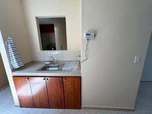 a kitchen with a sink and a refrigerator at Oasis House 2 in Tocumen