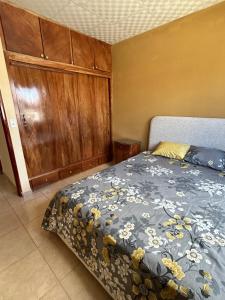 a bedroom with a bed and a wooden cabinet at Oasis House 2 in Tocumen