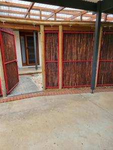 a building with red gates in front of it at Treasure in Karabah in Queanbeyan