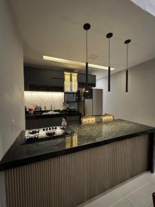 a kitchen with a stove and a counter top at Casa Belchior in Sobral