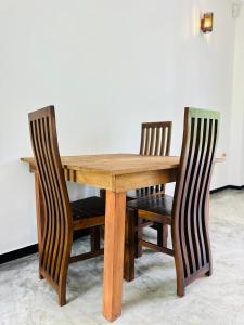 a wooden table with two chairs around it at Dacha Retreat in Midigama East +18 photos