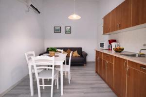 a kitchen and dining room with a table and chairs at Apartments Urban Porec in Poreč