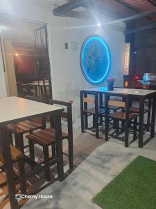 a dining room with tables and chairs and a blue orb at Hotel Chemy in Quito