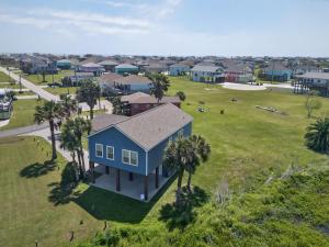 an aerial view of a house with palm trees at Caribbean Palm Retreat 3BR Near Crystal Beach Fireplace in Bolivar Peninsula +42 photos