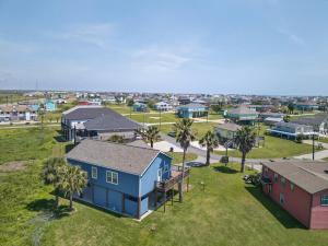 an aerial view of a town with houses and palm trees at Caribbean Palm Retreat 3BR Near Crystal Beach Fireplace in Bolivar Peninsula