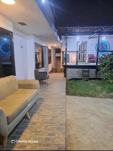 a living room with a couch and chairs in a room at Hotel Chemy in Quito
