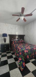 a bedroom with a bed and a ceiling fan at E & E Motel in Myrtle Beach