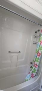 a bath tub with a shower curtain in a bathroom at E & E Motel in Myrtle Beach +6 photos