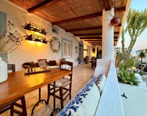 a living room with a table and a couch at La Giara in Vulcano