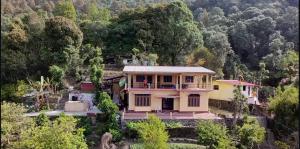 an aerial view of a house in the mountains at Harender nayal homestay in Bhīm Tāl