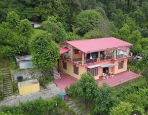 an overhead view of a house with a pink roof at Harender nayal homestay in Bhīm Tāl