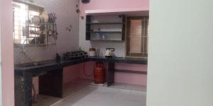 a kitchen with a sink and a counter top at JPR Cottage in Erode