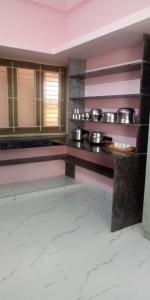 a kitchen with a counter with pots and pans at JPR Cottage in Erode