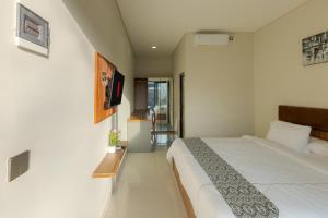 a bedroom with a large white bed in a room at DC 08 Residence in Dalung +41 photos