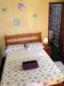 Ένα ή περισσότερα κρεβάτια σε δωμάτιο στο Pousada Oásis Ilha Grande