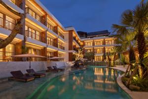 an exterior view of a hotel with a swimming pool at Anumana Ubud Hotel in Ubud