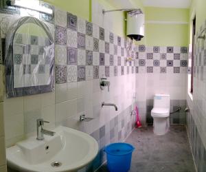 a bathroom with a sink and a toilet at Hotel Sunrise in Lachen