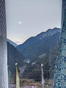 a view of a mountain valley from a window at Hotel Sunrise in Lachen