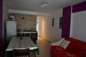 a kitchen with a table and a refrigerator in a room at Mdp in Mar del Plata