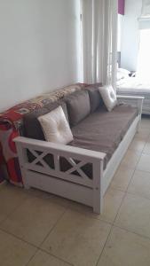 a white bed with pillows on it in a room at Mdp in Mar del Plata +1 photo