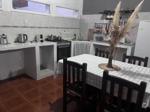 a kitchen with a table with a vase on it at La martinez in San Antonio de Areco