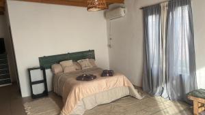 a bedroom with a bed with two shoes on it at La martinez in San Antonio de Areco