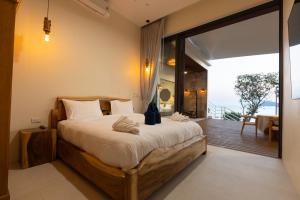 a bedroom with a large bed and a balcony at Villa Lotus in Ko Phangan +75 photos