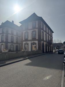 a large building on the side of a street at Studio de la Doller in Masevaux
