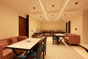 a restaurant with tables and chairs in a room at RLS Hotels, Greater Noida Near Expo Centre & Mart in Greater Noida